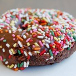 Chocolate Rainbow Sprinkle Devils food chocolate cake dipped in chocolate frosting and rainbow sprinkles.